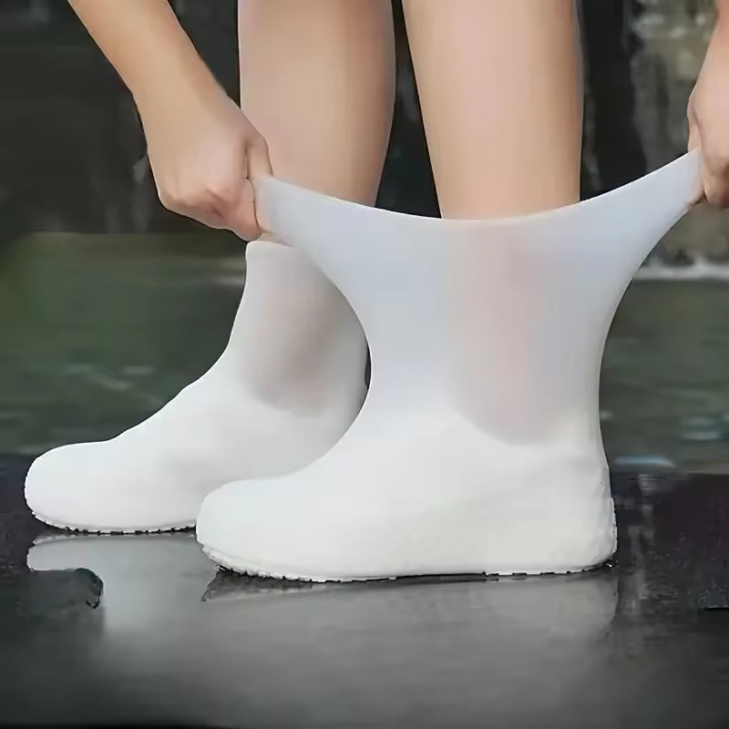 Clarify.pk reusable waterproof shoe covers in white being stretched over shoes for protection