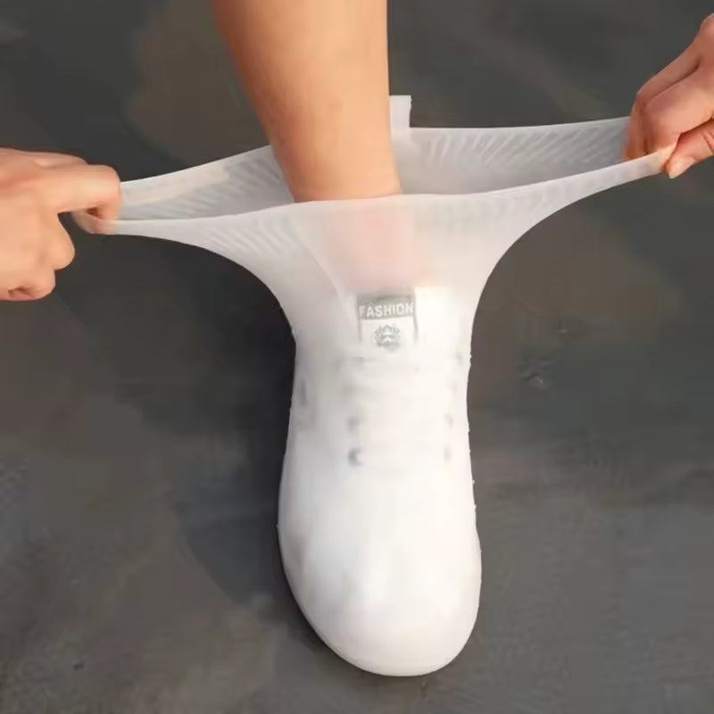 Clarify.pk reusable waterproof shoe covers being stretched over a shoe for protection