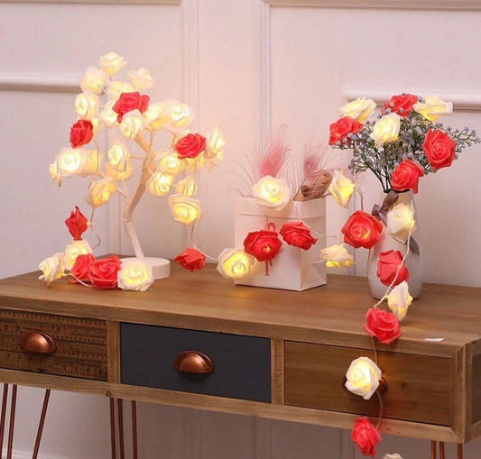 Rose fairy lights for bedroom decor featuring glowing red and white rose-shaped string lights on wooden table