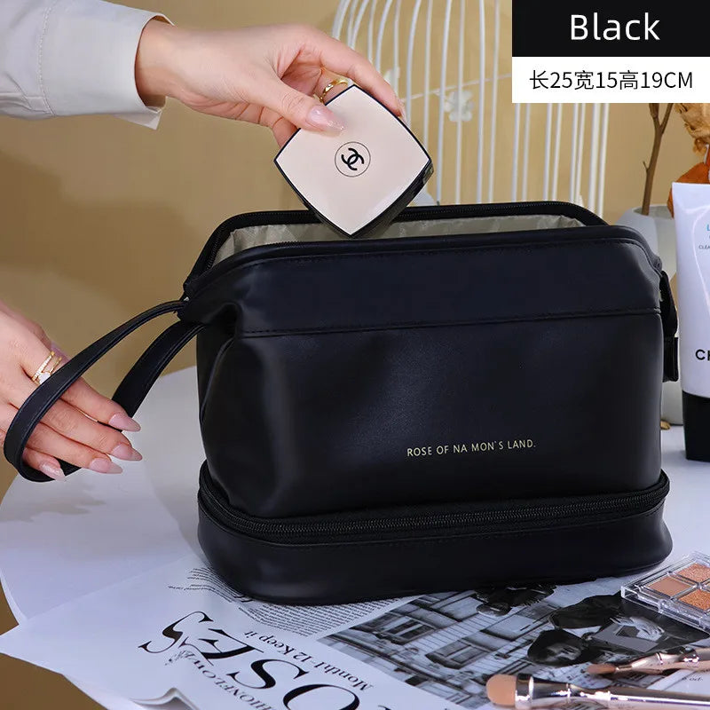 Black PU leather travel makeup bag with wrist strap and spacious compartments by Clarify.pk