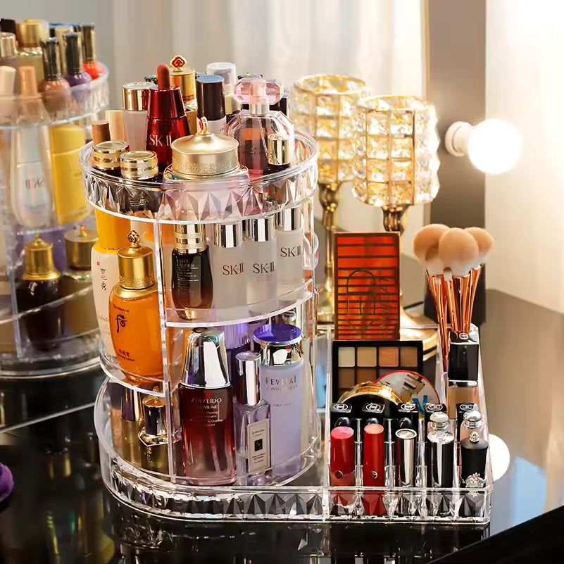 Rotating cosmetic storage box by Clarifypk holding various makeup bottles lipsticks and brushes on a vanity