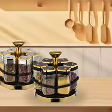 Clarify.pk rotating spice jar set with multiple glass containers and gold accents on kitchen counter