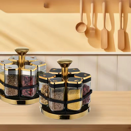 Clarify.pk rotating spice jar set with gold and black lids displayed on kitchen countertop