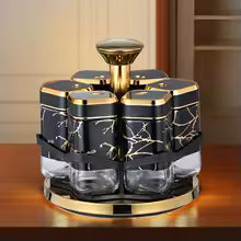 Clarify.pk rotating spice jar set with black and gold marble design and transparent glass containers