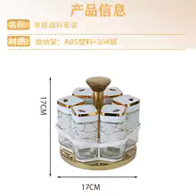 Clarify.pk rotating spice jar set with clear glass containers and gold lids on a gold base