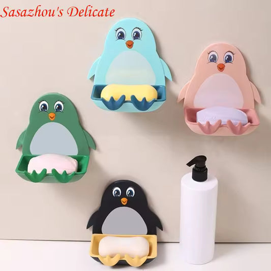 Set of colorful penguin soap holder wall mount designs with bars of soap in green, blue, pink, and black