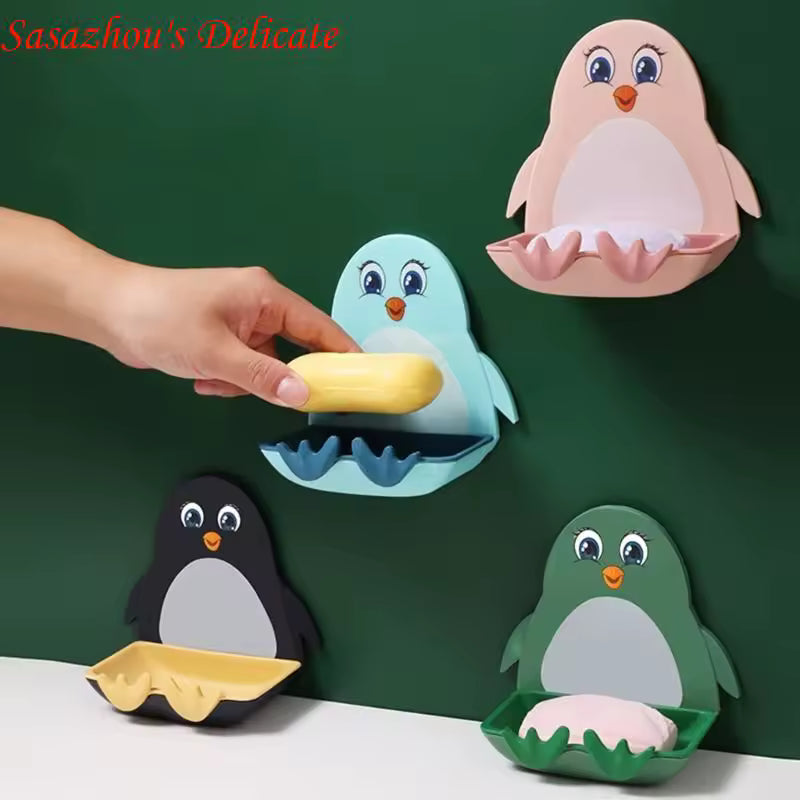 Colorful penguin soap holder wall mount set with pink, blue, black, and green designs holding soap bars