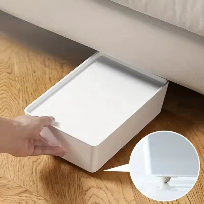 White storage box being moved easily on wooden floor using self adhesive furniture wheels by Clarify.pk