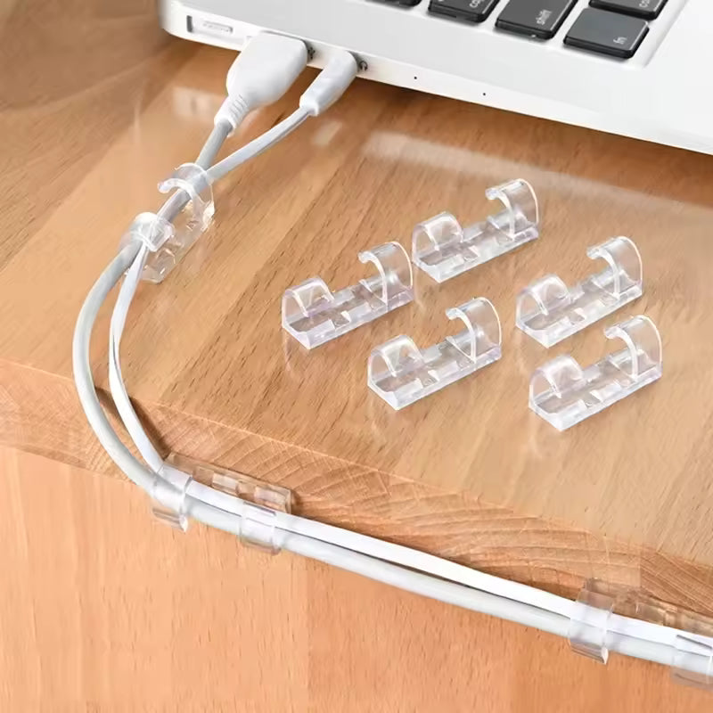 Clarify.pk clear self adhesive wire holder cable organizer clips securing white charging cables on wooden desk
