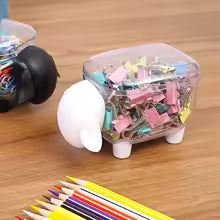Sheep shaped cotton swab holder filled with colorful binder clips on wooden surface