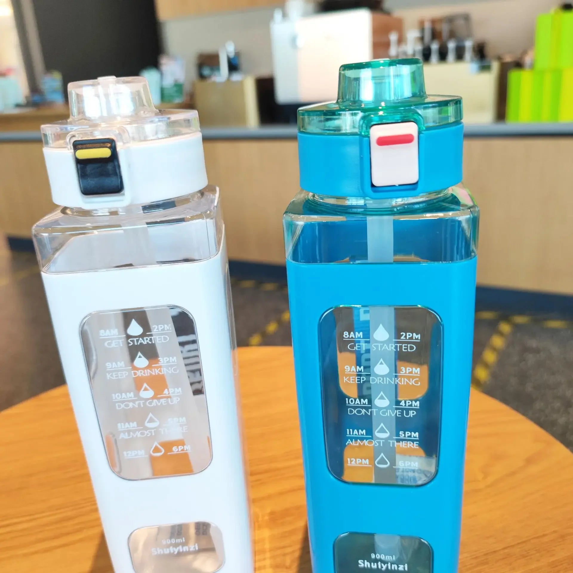 Clarify.pk 900ml leak proof water bottle in blue and white with time markers for hydration tracking