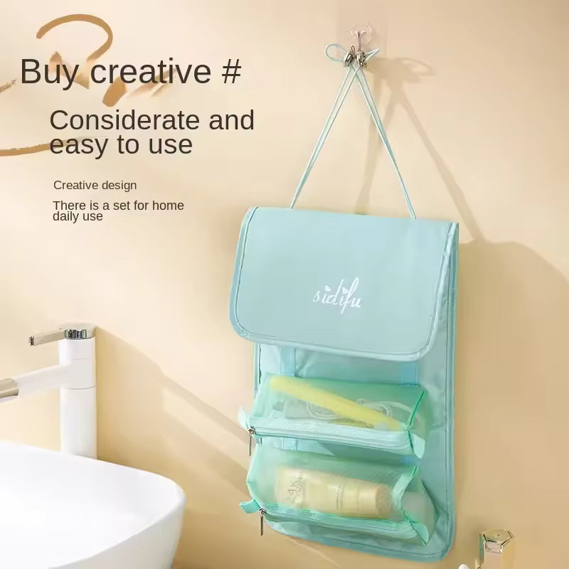 Light blue detachable hangable toiletry bag with multiple compartments hanging near bathroom sink