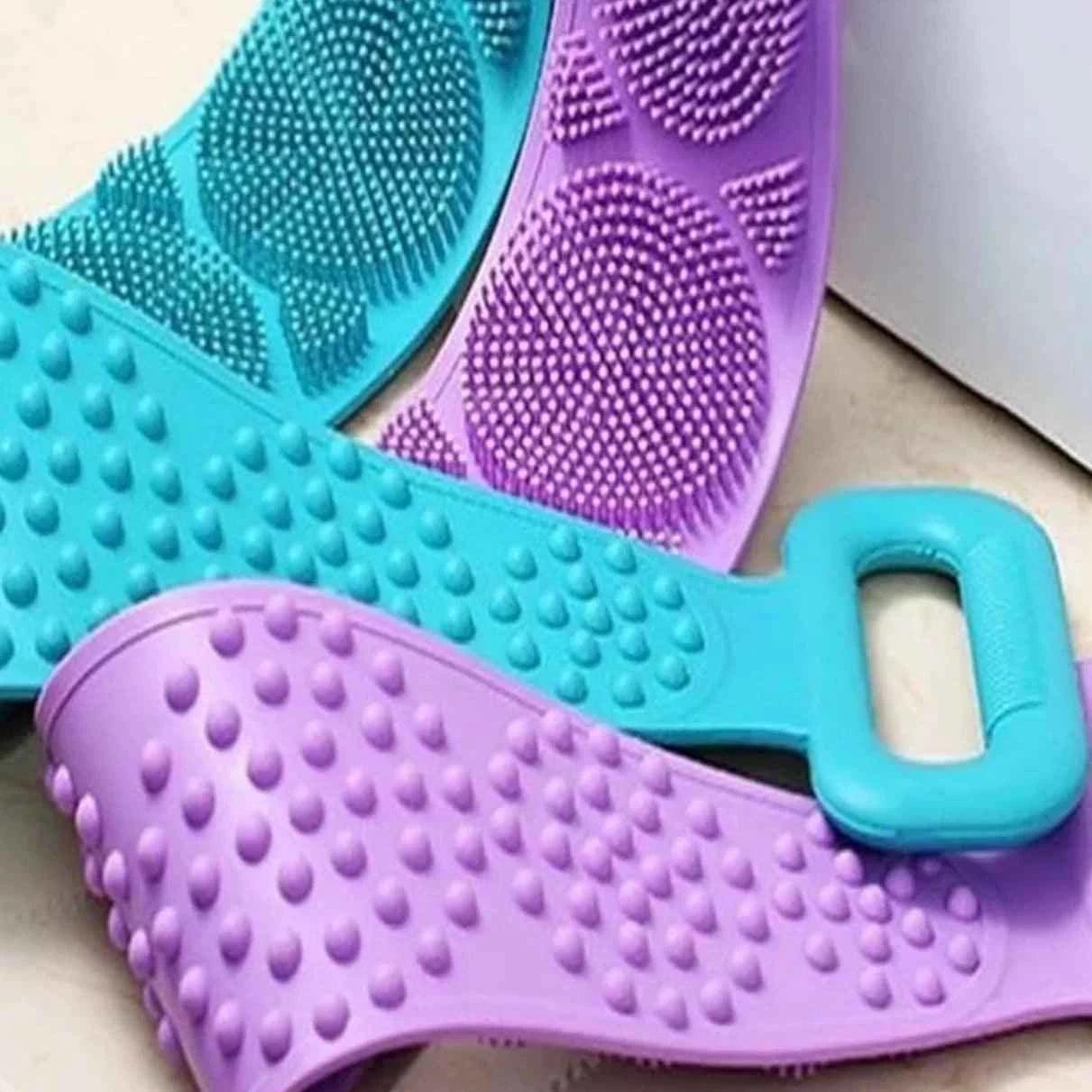 Purple and blue silicone body scrubber with textured bristles and handle for effective exfoliating