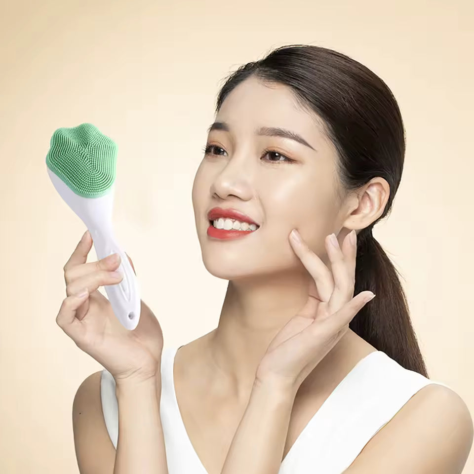 Woman holding a green and white silicone face cleaning brush with soft bristles for gentle skin care