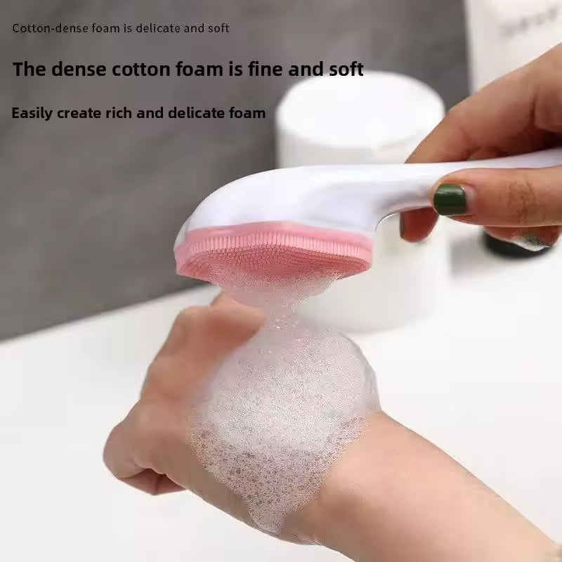 Silicone facial cleansing brush creating dense cotton foam on hand for gentle skin cleansing