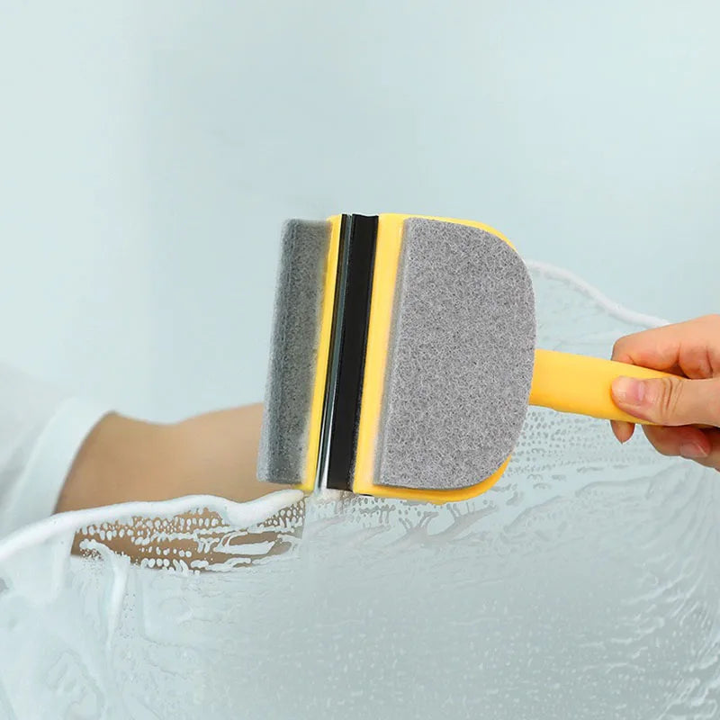 Clarify.pk silicone glass cleaner wiper with yellow handle cleaning a glass surface