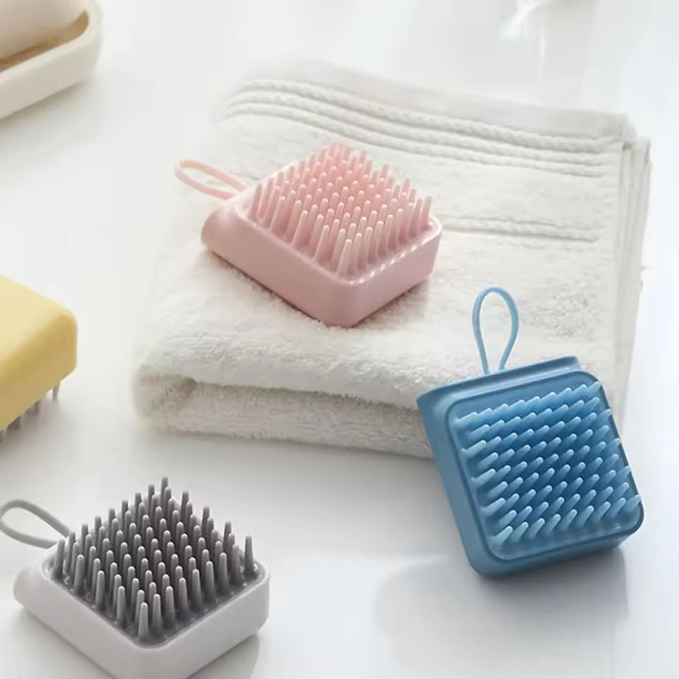 Clarify.pk silicone head massager brush in pink blue and gray with soft silicone bristles on white background