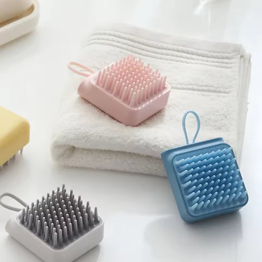 Clarify.pk silicone head massager brush in pink blue and gray with soft silicone bristles on white background