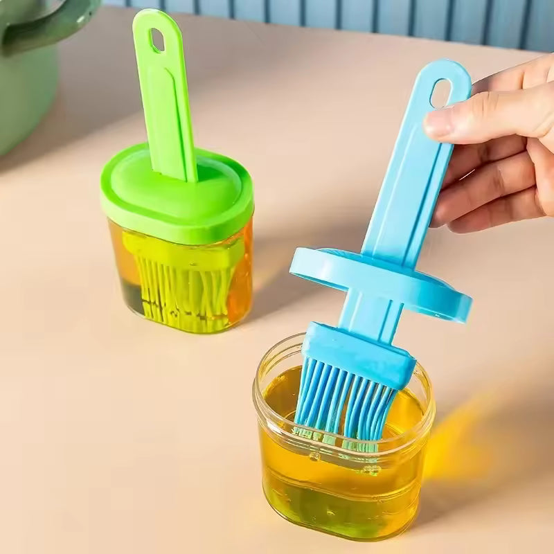 Clarify.pk silicone oil brush for baking with blue and green handles dipping in oil containers