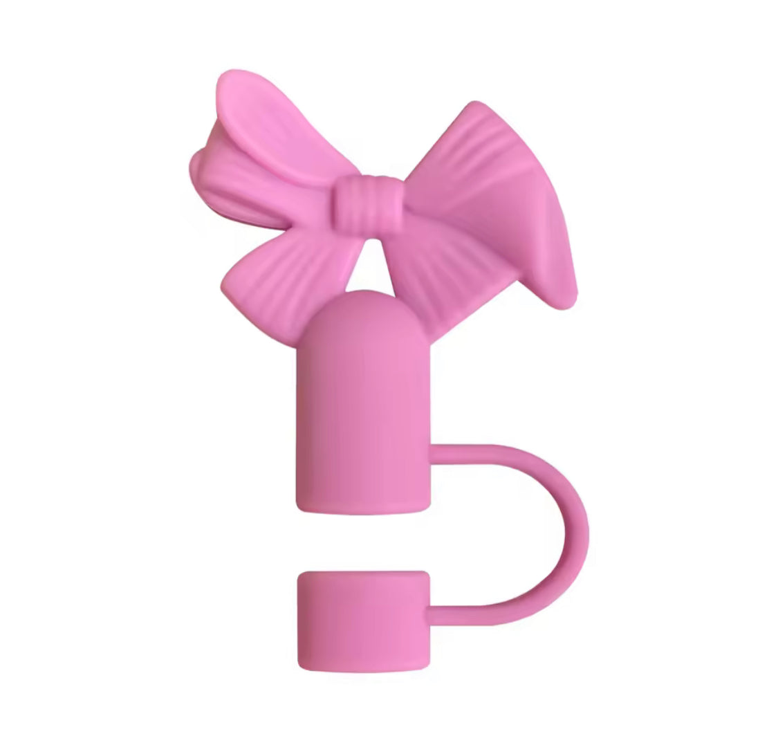 Pink bow-shaped silicone straw toppers designed to decorate and seal reusable straws