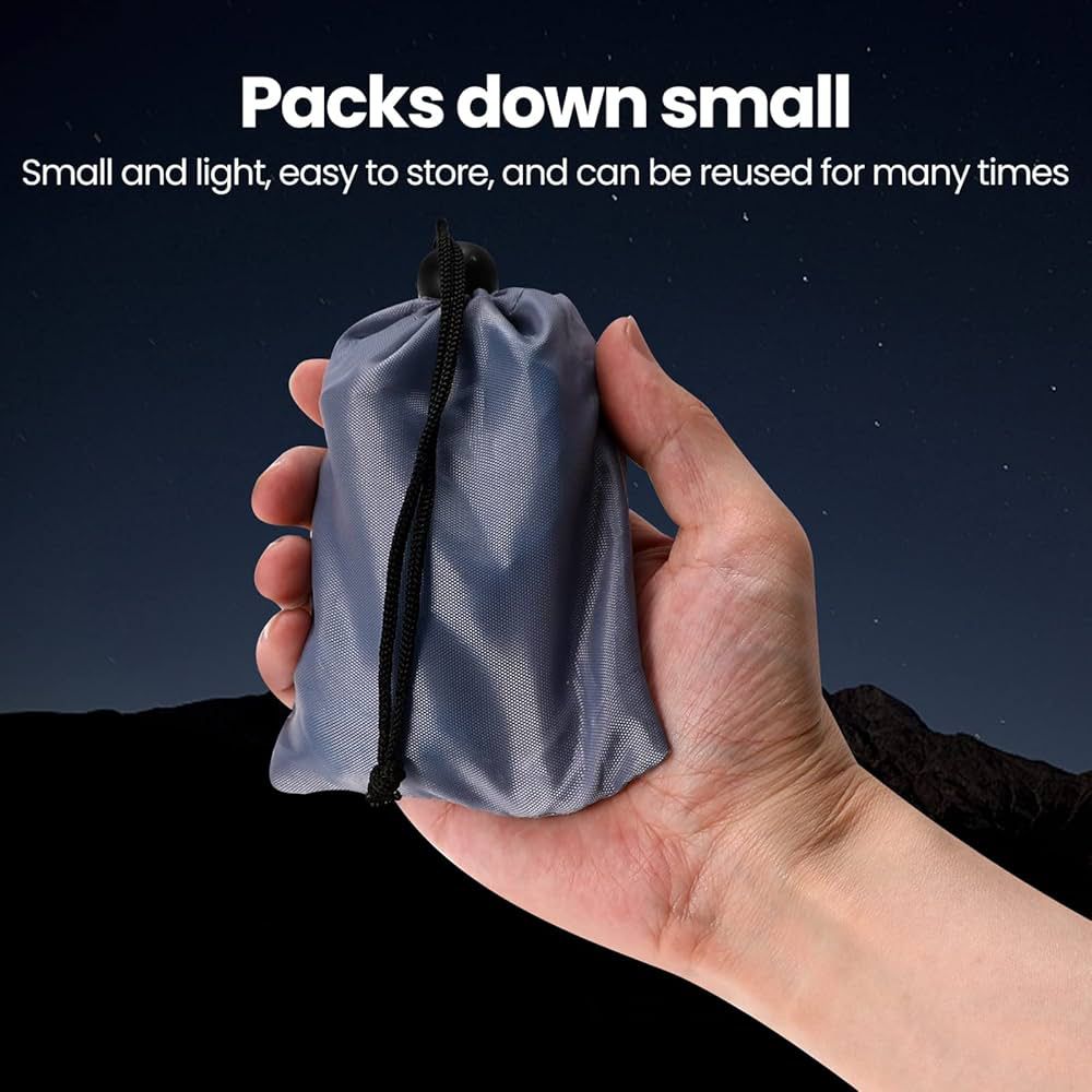 Compact camping inflatable light packed small in a gray drawstring bag held in hand for easy storage