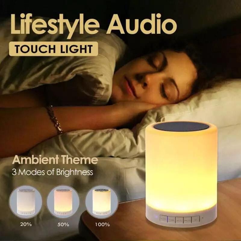 Wireless bluetooth speaker with led lamp on nightstand emitting ambient light with three brightness modes