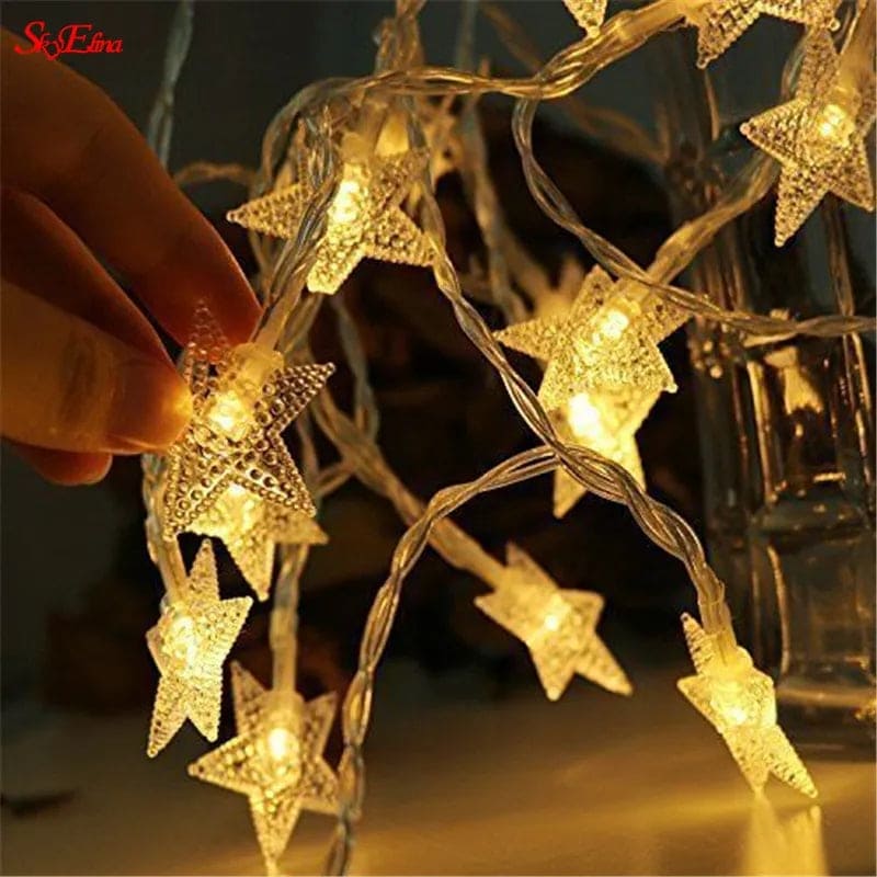 LED star curtain lights for decoration glowing warmly in a hand-held star-shaped design