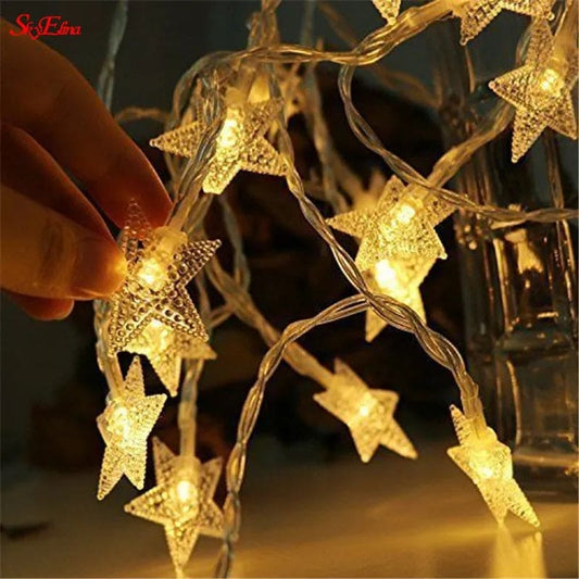 LED star curtain lights for decoration glowing warmly in a hand-held star-shaped design