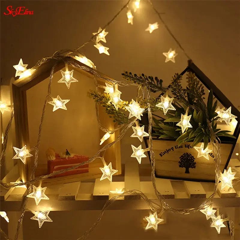LED star curtain lights for decoration glowing warmly around wooden shelves with plants
