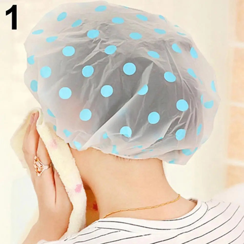 Clarify.pk spa hair salon shower cap with blue polka dots worn by person drying face with towel