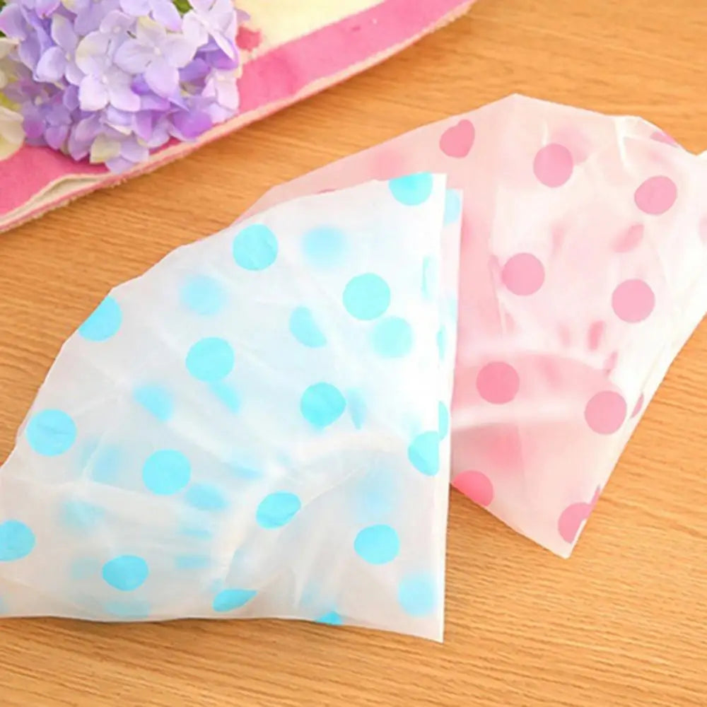 Clarify.pk spa hair salon shower cap with blue and pink polka dots on a wooden surface