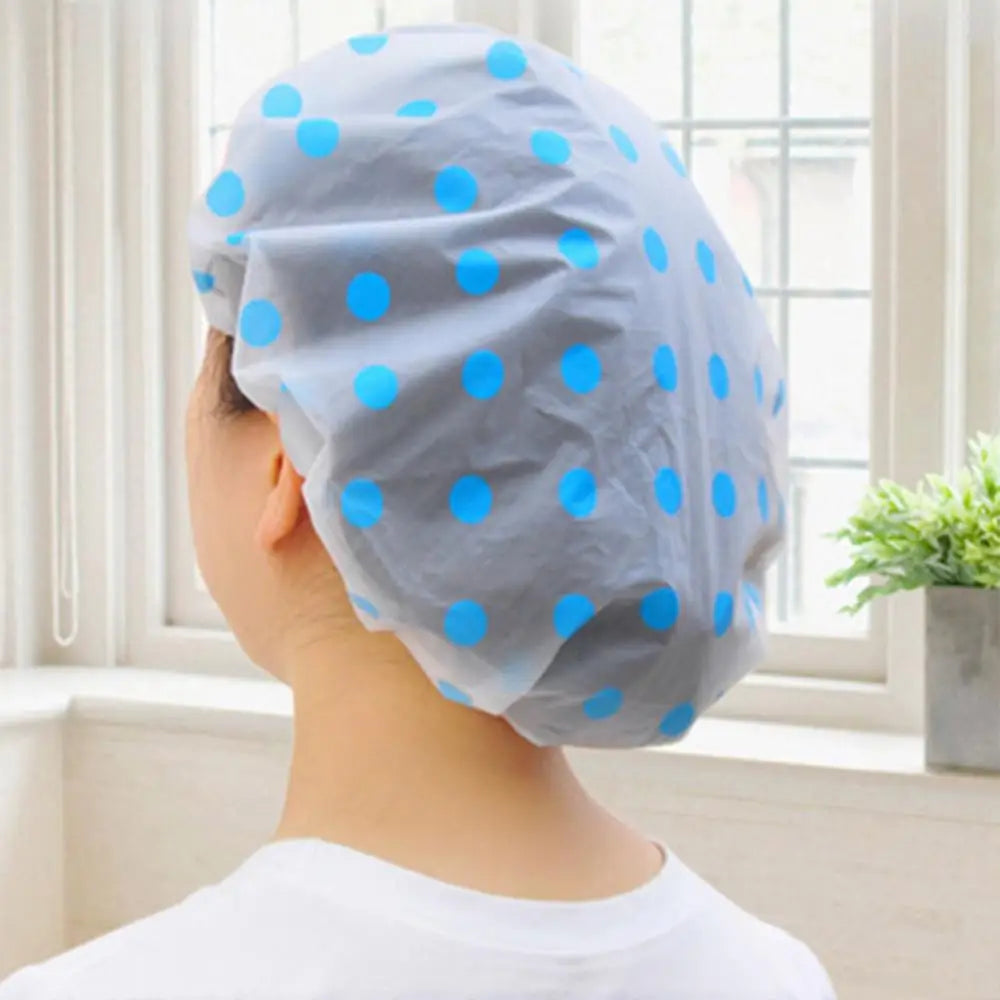 Clarify.pk spa hair salon shower cap with blue polka dots worn by a person in a bright bathroom