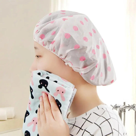 Clarify.pk spa hair salon shower cap with pink polka dots worn by person drying face with towel