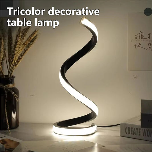 Clarify.pk spiral LED table lamp with modern tricolor decorative design on a desk