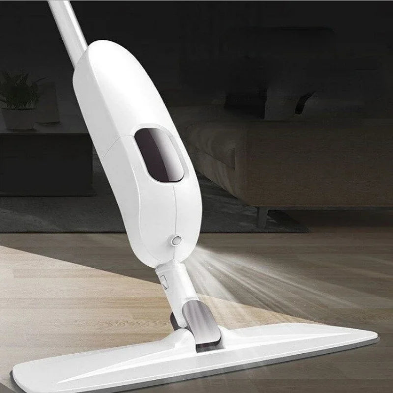 Clarify.pk white spray mop spraying cleaning solution on hardwood floor in living room