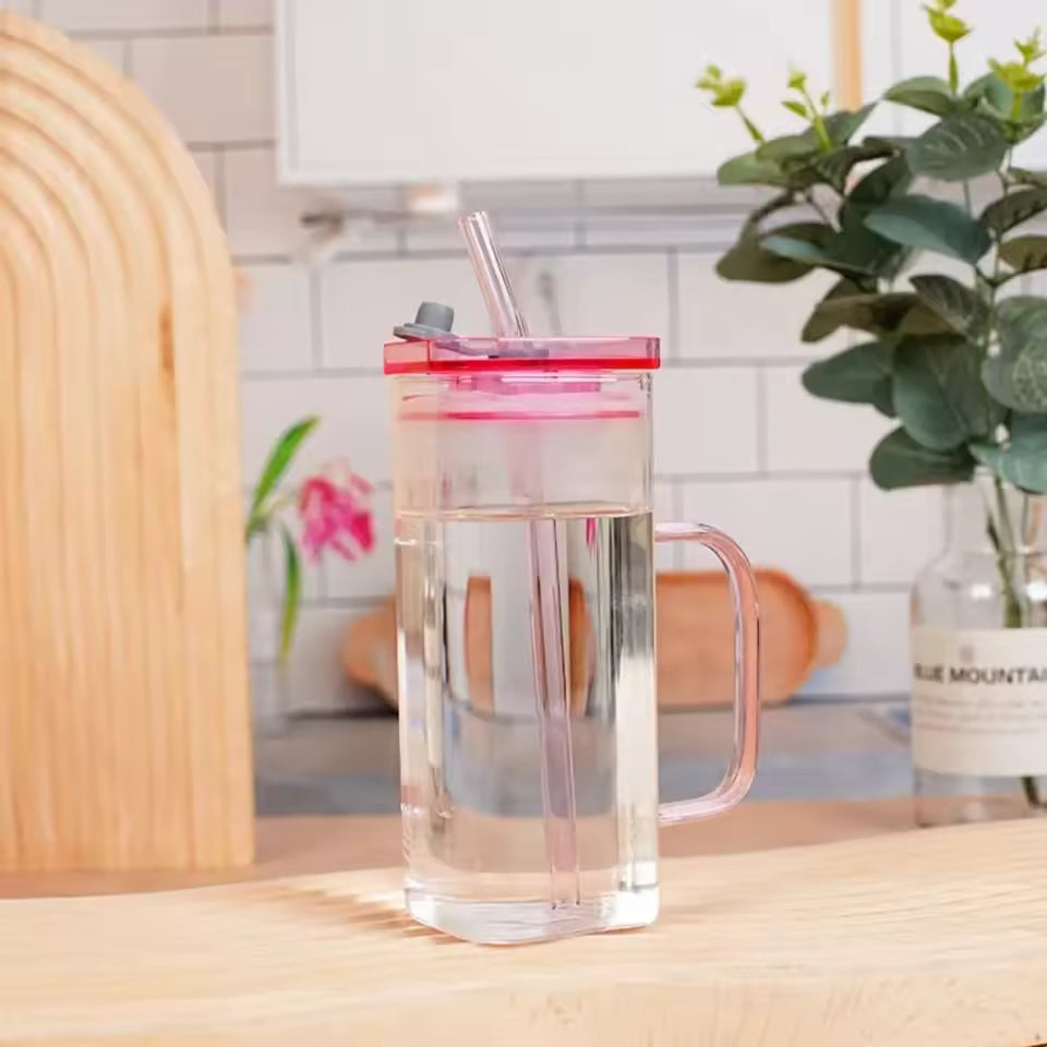Clarify.pk transparent glass bottle with pink lid and handle on wooden table for coffee or water