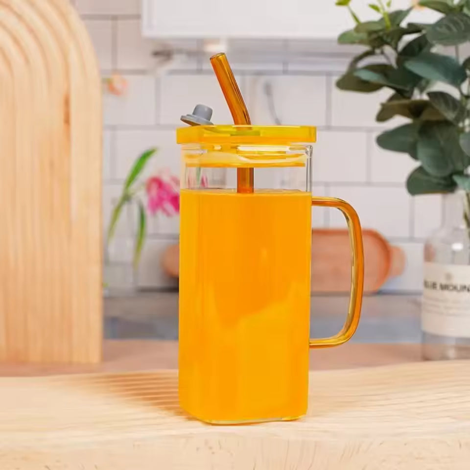 Clarify.pk transparent glass bottle coffee mug with yellow lid and handle on kitchen counter