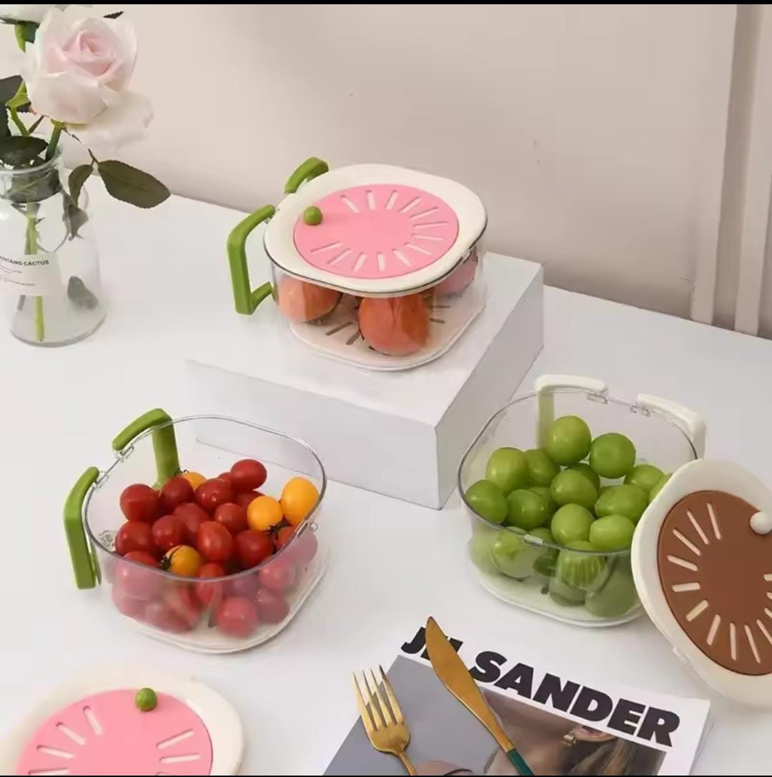 Clear stackable kitchen storage containers with green handles filled with grapes and cherry tomatoes