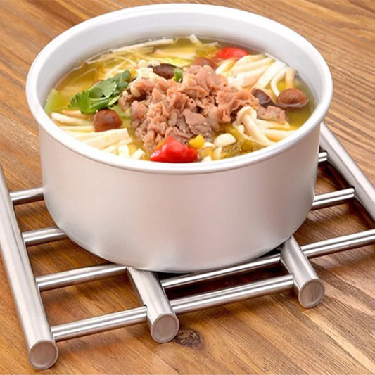 Clarify.pk stainless steel heat insulated rack holding a white bowl of soup on wooden surface