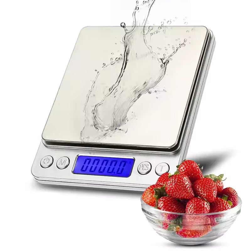 Stainless steel kitchen weighing scale with digital display and water splash, next to a bowl of fresh strawberries
