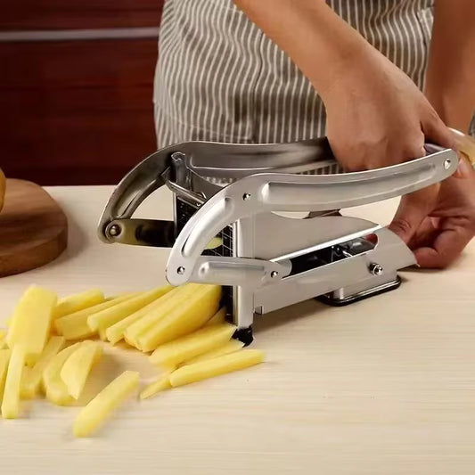 Stainless steel potato cutter slicing potatoes into fries on white countertop