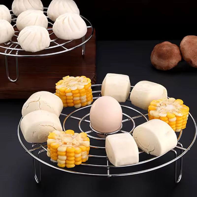 Clarify round trivet rack for cooking holding corn, egg, and steamed buns on a black surface