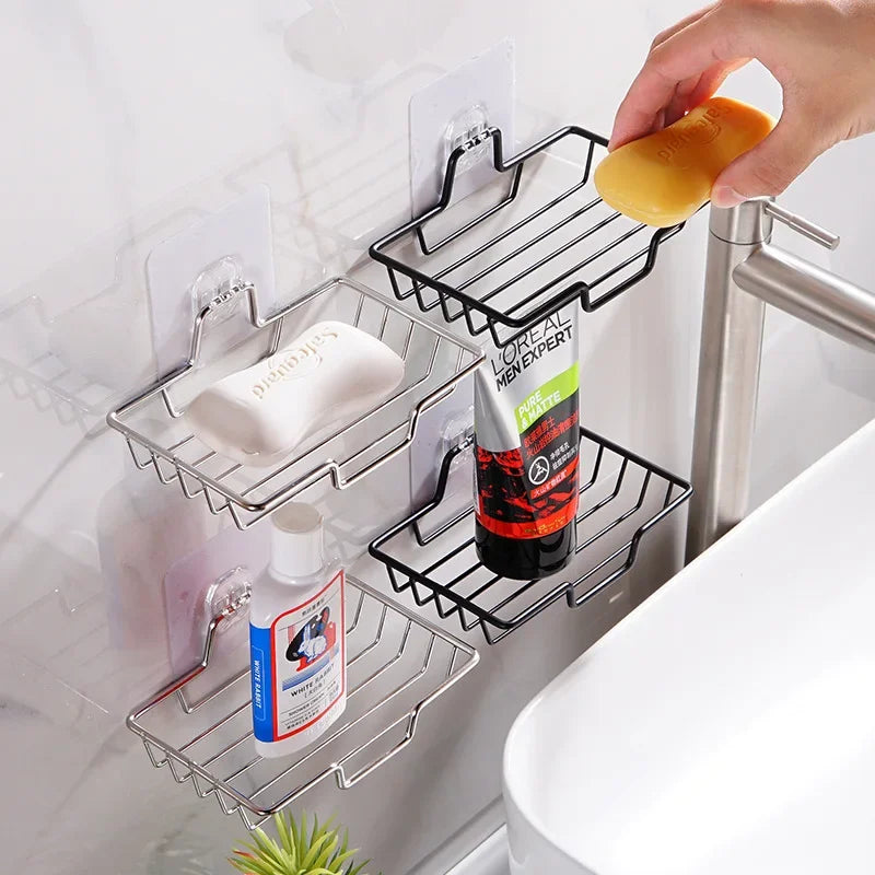Wall-mounted stainless steel soap dish holding soap bars and toiletries near bathroom sink