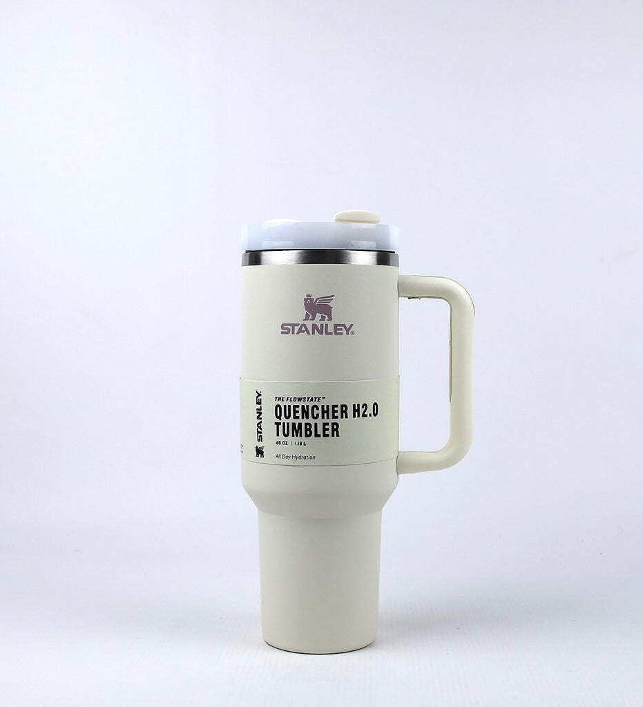 40oz stainless steel tumbler with handle in cream color featuring Stanley Quencher H2.0 branding