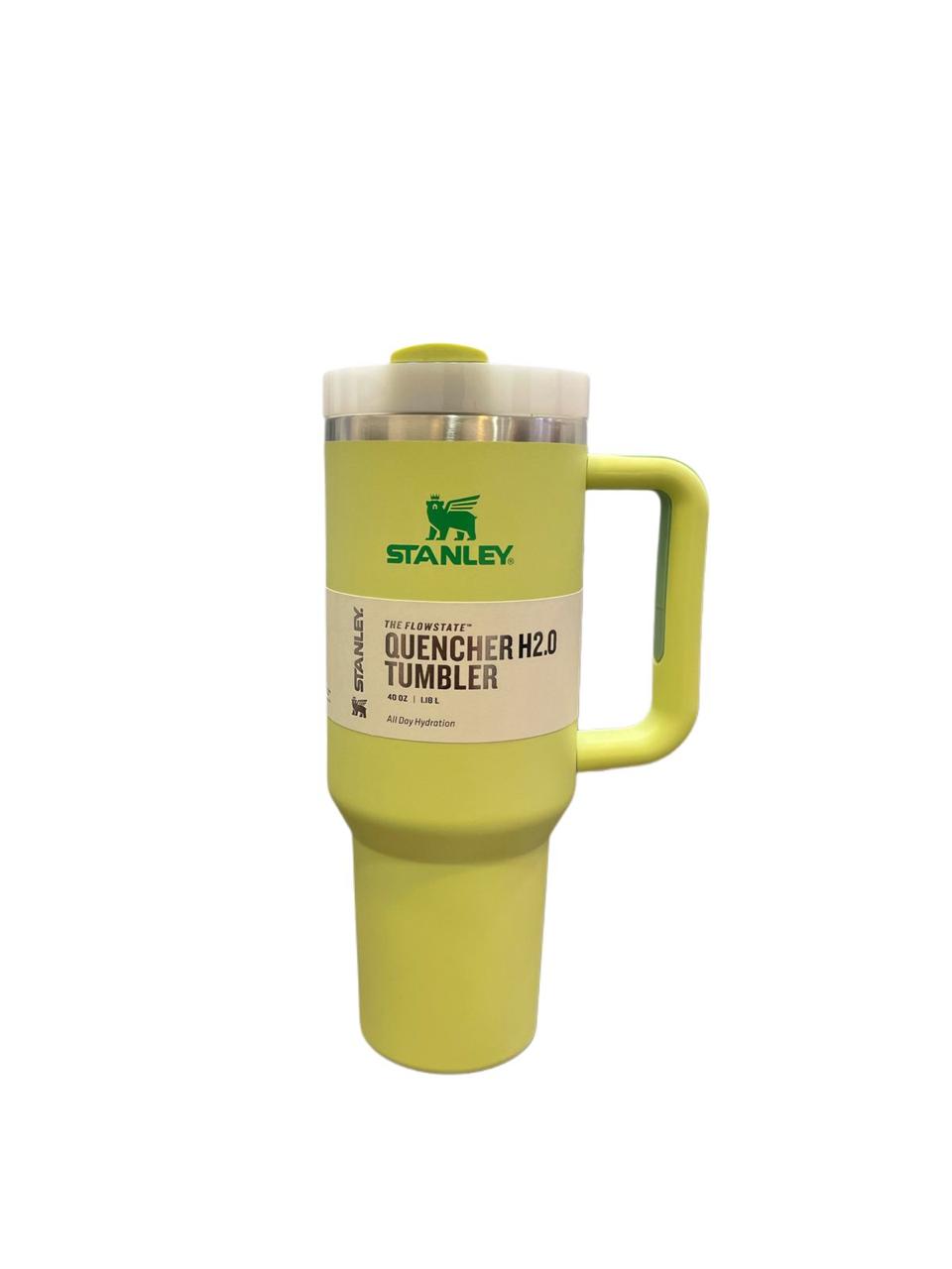 Green 40oz stainless steel tumbler with handle by Stanley with clear lid for hot and cold drinks