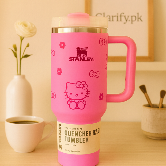 Stanley quencher tumbler pink with Hello Kitty design and handle on wooden table from Clarify.pk
