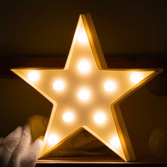 Illuminated star shape LED night lamp glowing with warm white lights in a dark room