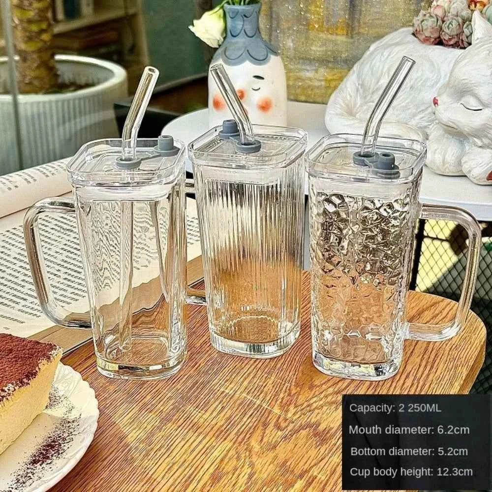 Three stylish square glass mugs with straws, featuring different textural designs for versatile use