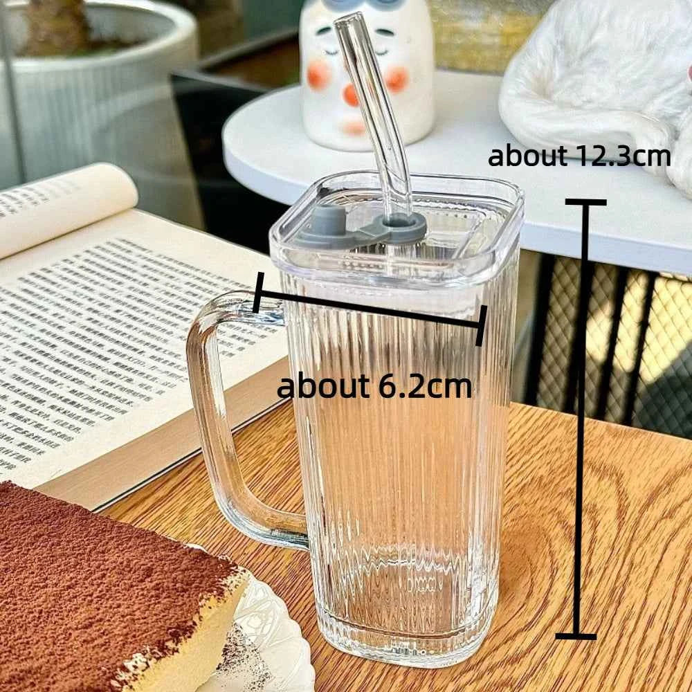 Stylish square glass mug with a clear design and a straw, perfect for beverages at home