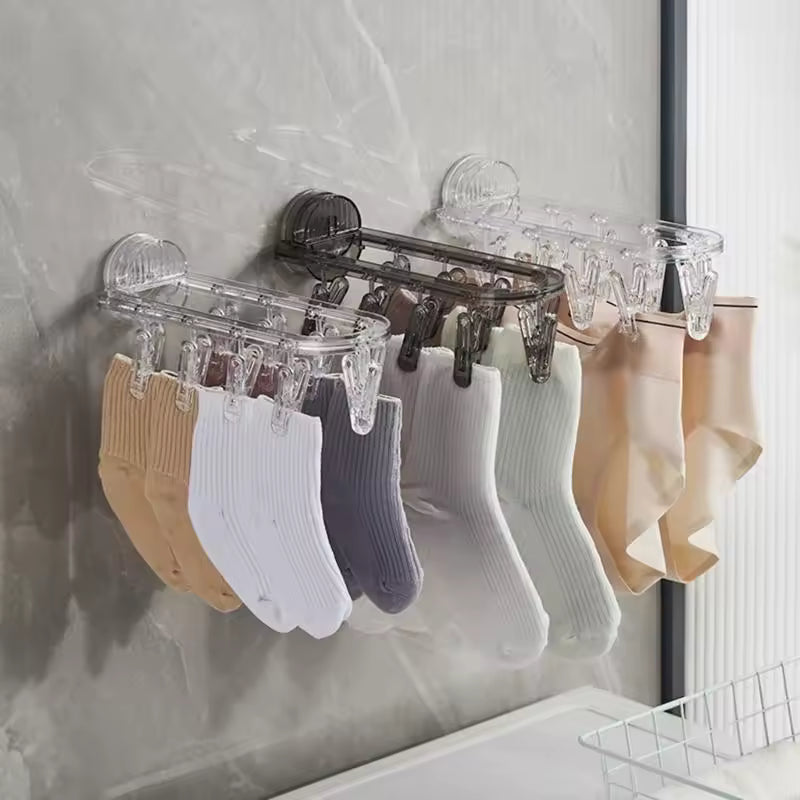 Clarify.pk suction clothes hanger rack with multiple clips holding various socks and hosiery on a wall